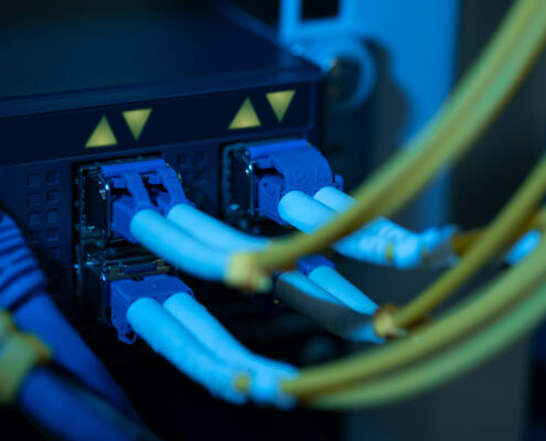 blue and yellow fiber optic cords plugged into Spectralink Link 3000
